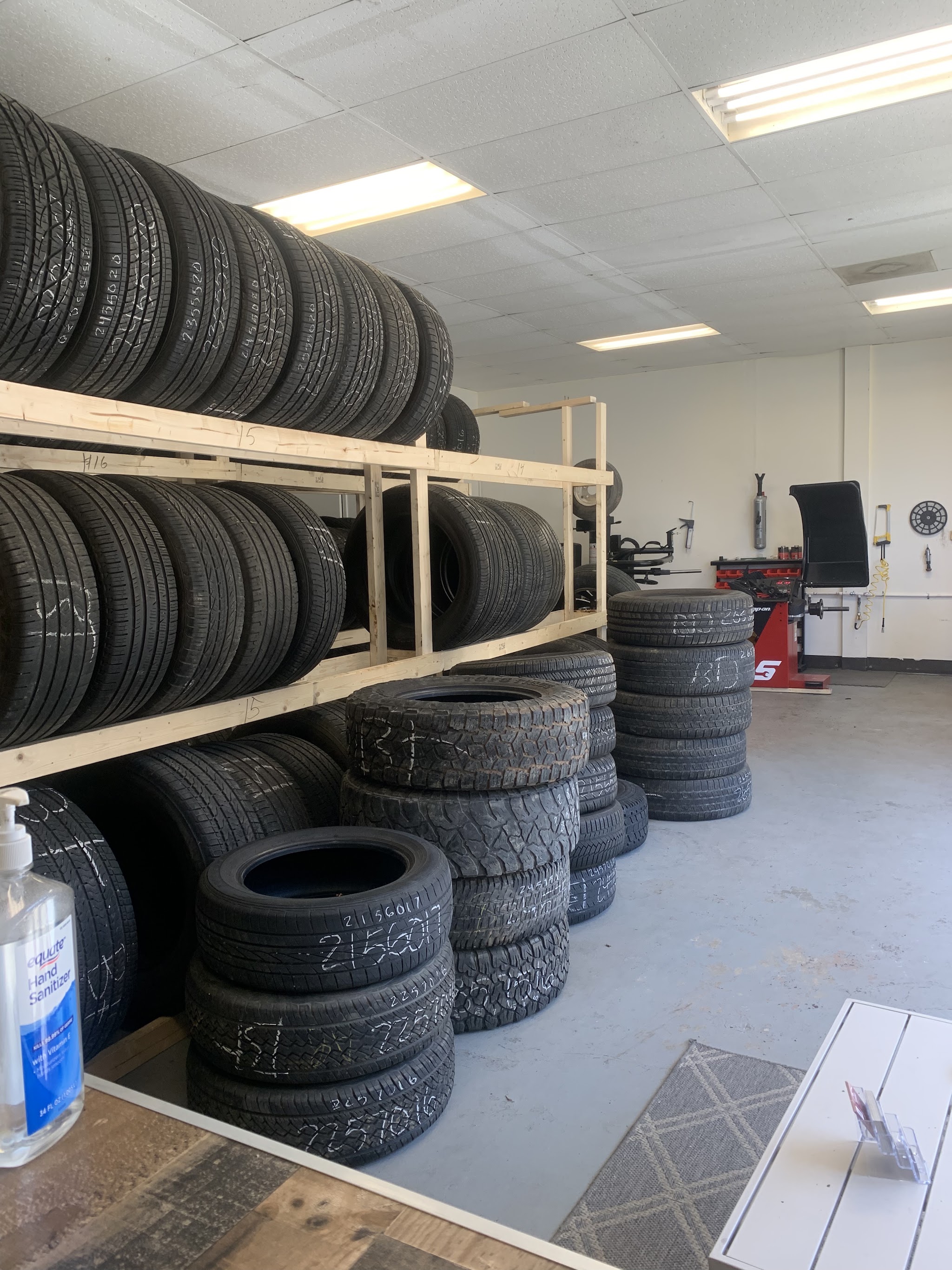 Racks of used tires, each marked with its size, and our tire machines at the back