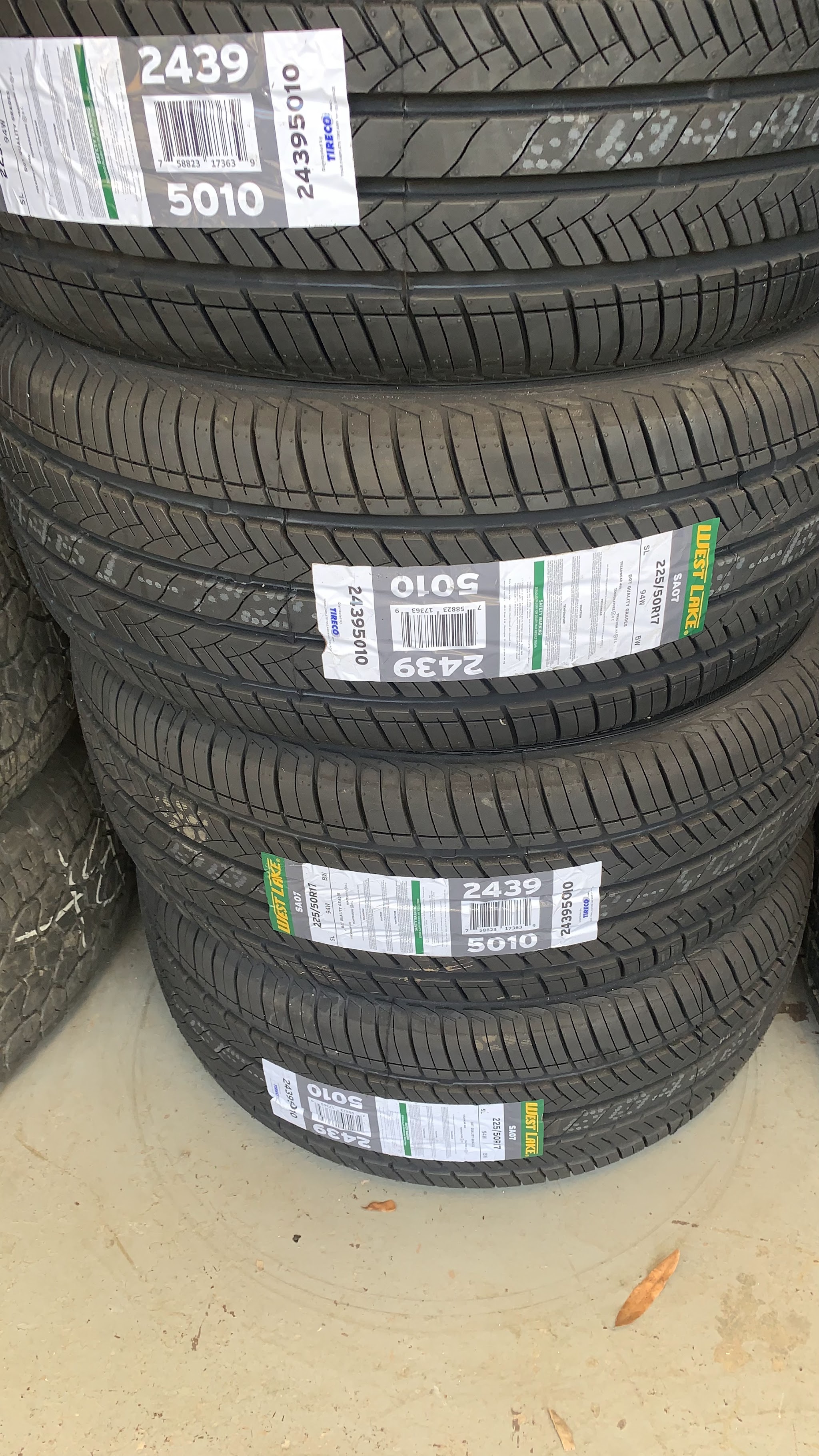 A stack of new tires with their labels still on