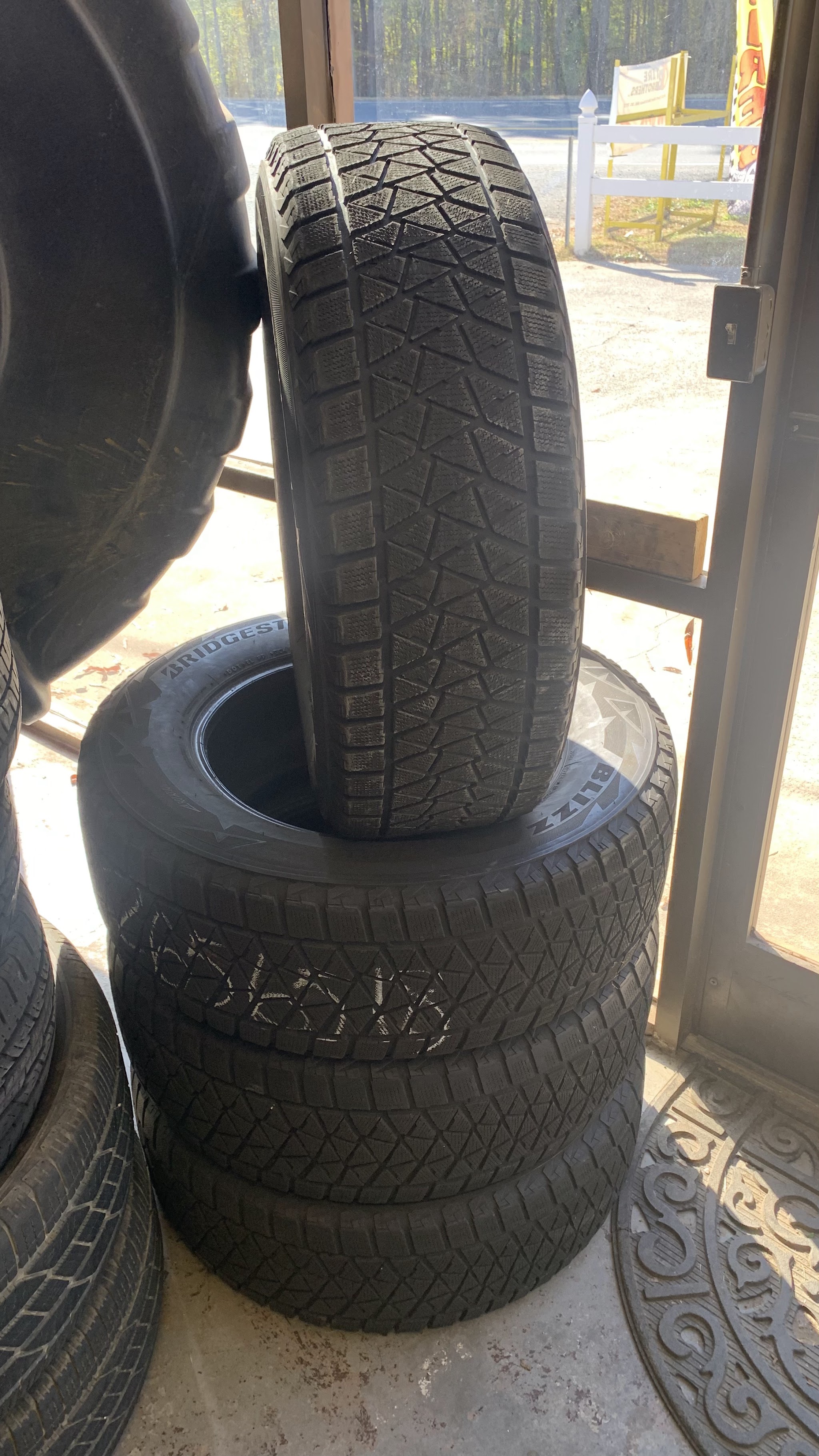 Winter tires stacked by our front door